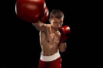 Image showing Male boxer boxing with dramatic edgy lighting in a dark studio