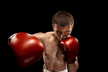 Image showing Male boxer boxing with dramatic edgy lighting in a dark studio