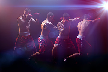 Image showing The boxer boxing in a dark studio