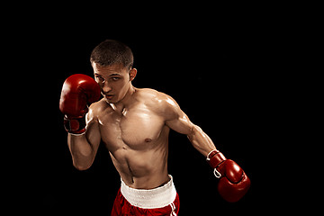 Image showing Male boxer boxing with dramatic edgy lighting in a dark studio