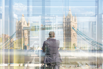 Image showing British businessman talking on mobile phone in London city, UK.