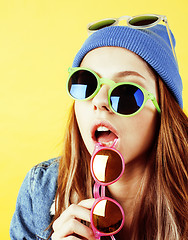 Image showing lifestyle people concept: pretty young school teenage girl having fun happy smiling on yellow background 