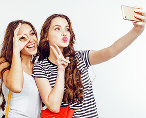 Image showing best friends teenage girls together having fun, posing emotional on white background, besties happy smiling, lifestyle people concept close up