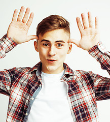 Image showing young handsome teenage hipster guy posing emotional, happy smiling against white background isolated, lifestyle people concept 