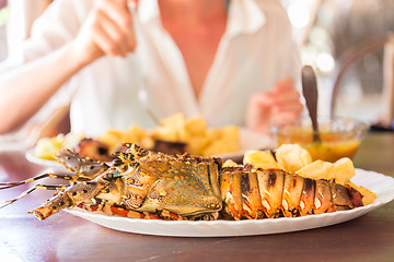 Image showing Grilled lobster served with potatoes and coconut sauce.