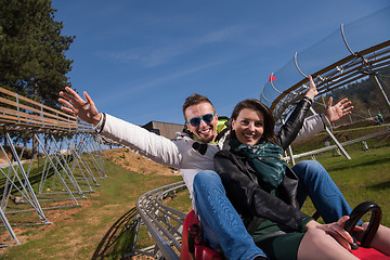 Image showing couple enjoys driving on alpine coaster