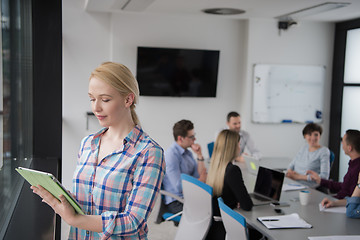 Image showing Pretty Businesswoman Using Tablet In Office Building by window