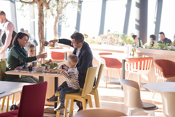 Image showing Young parents enjoying lunch time with their children