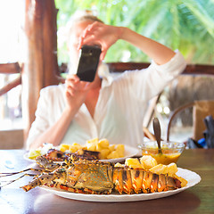 Image showing Grilled lobster served with potatoes and coconut sauce.