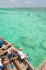 Image showing Woman snorkeling in clear shallow sea of tropical lagoon with turquoise blue water.