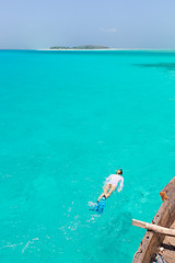 Image showing Woman snorkeling in clear shallow sea of tropical lagoon with turquoise blue water.
