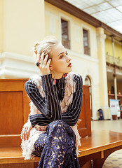 Image showing young attractive fashion lady on railway station waiting, vintage people concept in classic interior 