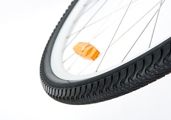 Image showing Bicycle wheel with orange reflector