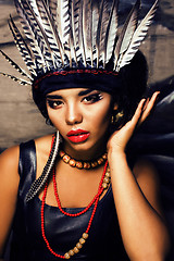 Image showing young pretty woman with make up like red indian, futher in hair,