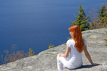 Image showing Girl sitting on a rock, enjoying the view