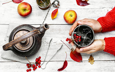 Image showing Palm of your hand with cup of autumn tea