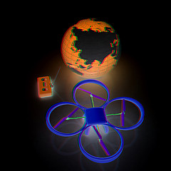 Image showing Quadrocopter Drone with Earth Globe and remote controller on a w