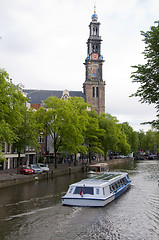 Image showing canal scene with tourist boat westekerk amsterdam