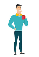 Image showing Young caucasian businessman holding cup of coffee.