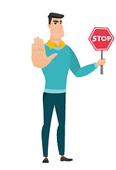 Image showing Caucasian businessman holding stop road sign.