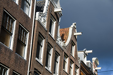 Image showing houses with hoist lift mechanism over canal amsterdam holland ne