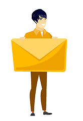 Image showing Smiling businessman holding a big envelope.