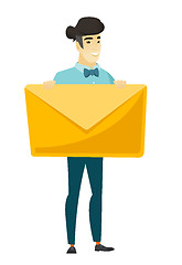 Image showing Smiling businessman holding a big envelope.