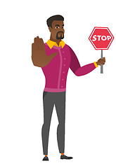 Image showing African businessman holding stop road sign.