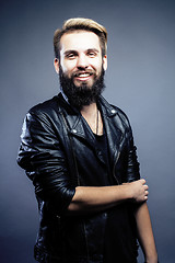 Image showing portrait of young bearded hipster guy on gray dark background close up, brutal modern man, lifestyle people concept 