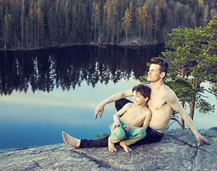 Image showing middle age man with little cute son doing sport yoga on the top of the mountain together, happy family lifestyle people outdoor, summer wild nature for training 