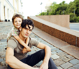 Image showing Young father hipster and his little son outside. Talking, teachi