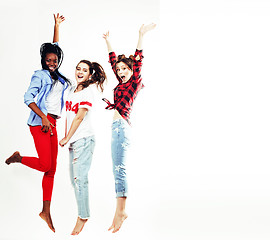 Image showing three pretty young diverse nations teenage girl friends jumping happy smiling on white background, lifestyle people concept 