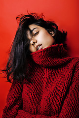 Image showing young pretty indian mulatto girl in red sweater posing emotional, fashion hipster teenage, lifestyle people concept