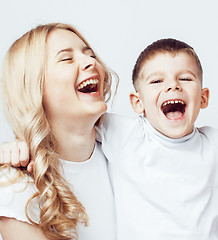 Image showing young modern blond mother with cute son together happy smiling family posing cheerful on white background, lifestyle people concept, sister and brother friends 