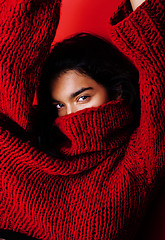 Image showing young pretty indian mulatto girl in red sweater posing emotional, fashion hipster teenage, lifestyle people concept