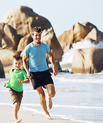 Image showing happy family on beach playing, father with son walking sea coast