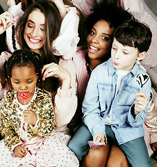 Image showing Lifestyle and people concept: young pretty diversity nations woman with different age children celebrating on birth day party together happy smiling, making selfie. African-american, asian and caucasi