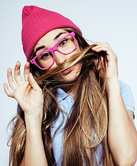 Image showing young pretty teenage hipster girl posing emotional happy smiling on white background, lifestyle people concept 