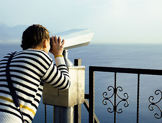 Image showing young woman looking through telescope at sea viewpoint in Ataturk park