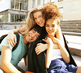 Image showing cute group of teenages at the building of university with books 