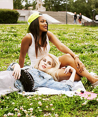 Image showing two young pretty teenager girls best friends laying on grass making selfie photo having fun, lifestyle happy people concept, students at summer 