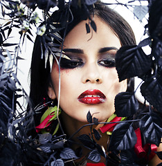 Image showing pretty brunette woman with rose jewelry, black and red, bright m