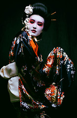 Image showing geisha in kimono on black