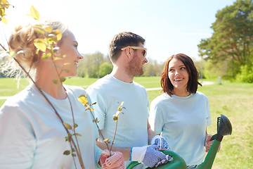 Image showing group of volunteers with tree seedlings in park