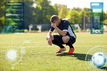 Image showing sad soccer player with ball on football field