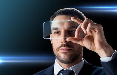 Image showing businessman with transparent smartphone