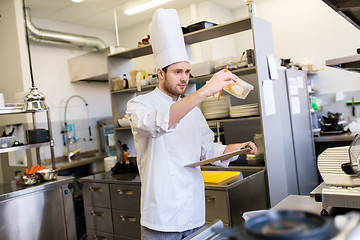 Image showing chef with clipboard doing inventory at kitchen