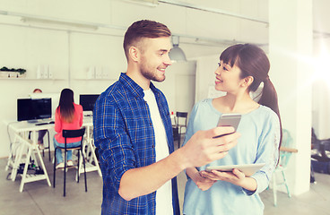 Image showing couple with smartphone and tablet pc at office