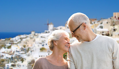 Image showing happy senior couple over santorini island