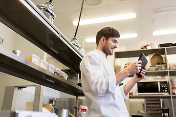 Image showing chef cook with tablet pc at restaurant kitchen